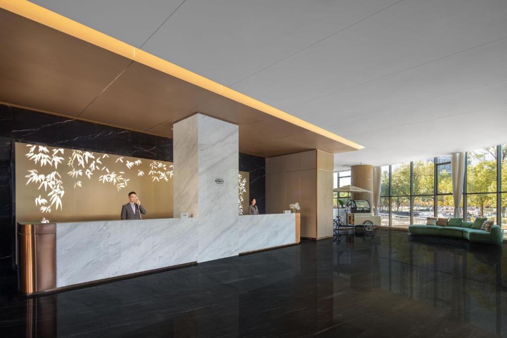 a man standing in the lobby of a building at Courtyard by Marriott Anji in Huzhou