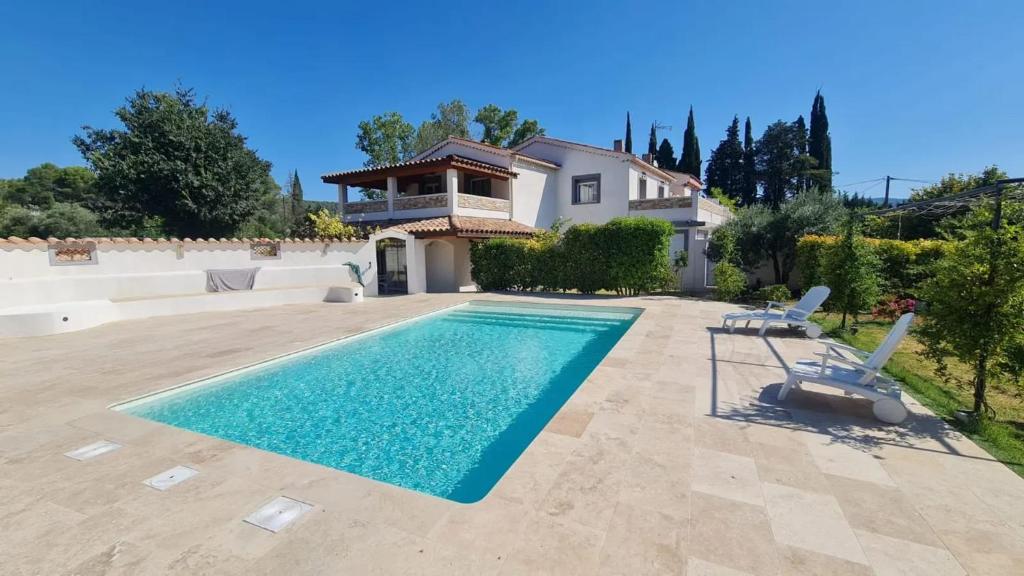 a villa with a swimming pool and a house at Villa charmante à Villecroze avec piscine privée in Villecroze