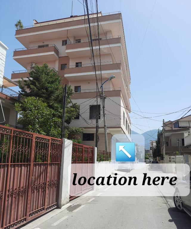 a sign on a fence in front of a building at Crew Hostel Tirana in Tirana
