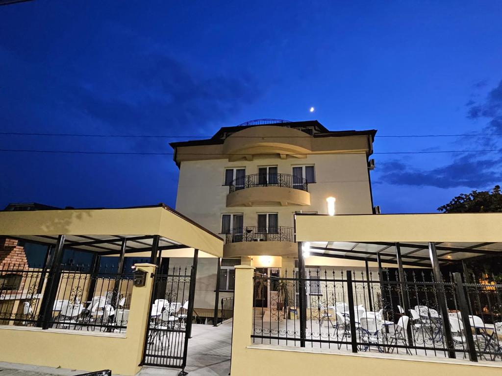 a building with a fence in front of it at Casa Andreea in Eforie Sud