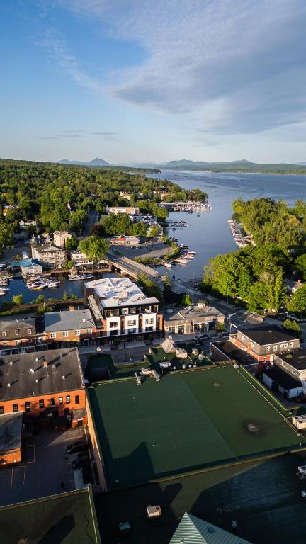 an aerial view of a city with a tennis court at Hôtel Expérience - Quartier Des Marinas in Magog-Orford