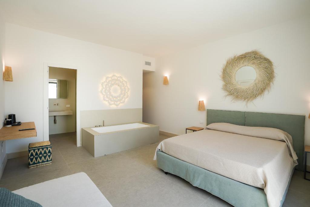 Postel nebo postele na pokoji v ubytování Corte dei Melograni Hotel Resort