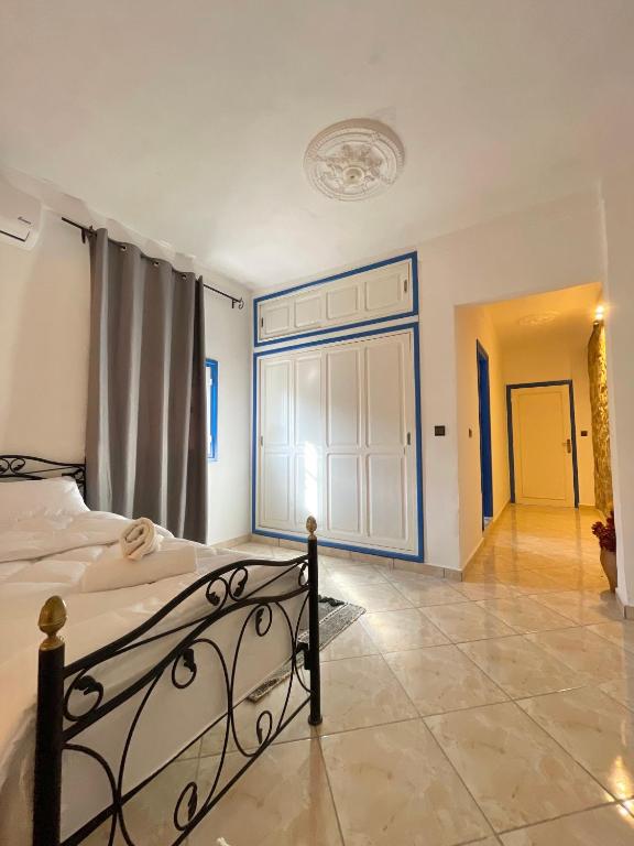 a bedroom with a bed and a large window at Dar Bakkali Nadi in Tangier