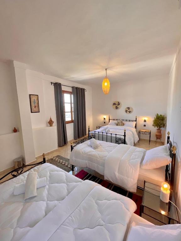 a bedroom with three beds in a room at Dar Bakkali Nadi in Tangier