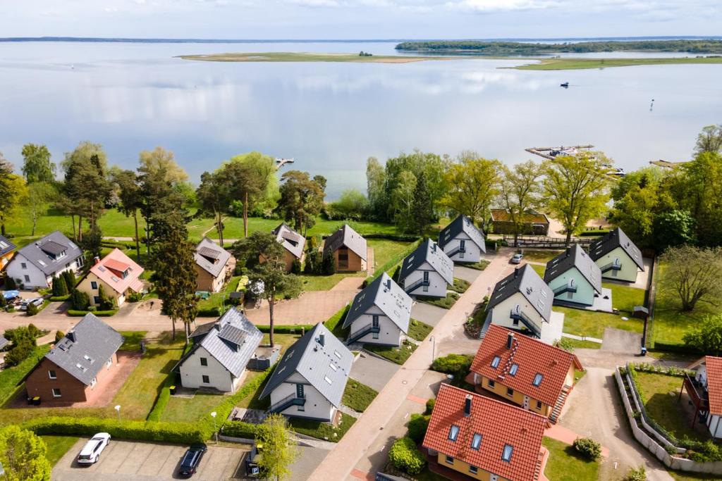 an aerial view of a small town with houses and a lake at Strandhaus 3 EG in Röbel