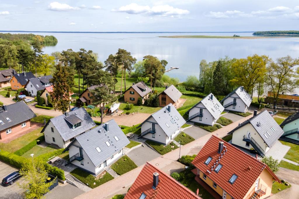 an aerial view of a town with houses and a lake at Strandhaus 3 OG in Marienfelde