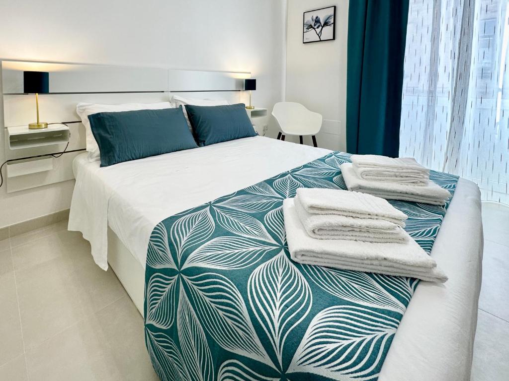 a bedroom with a large bed with towels on it at La Dimora del Corso appartamento in Campi Salentina