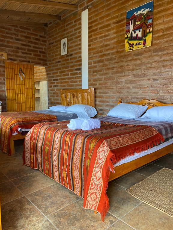 Postel nebo postele na pokoji v ubytování Casa Hotel Loma Wasi en Cotacachi