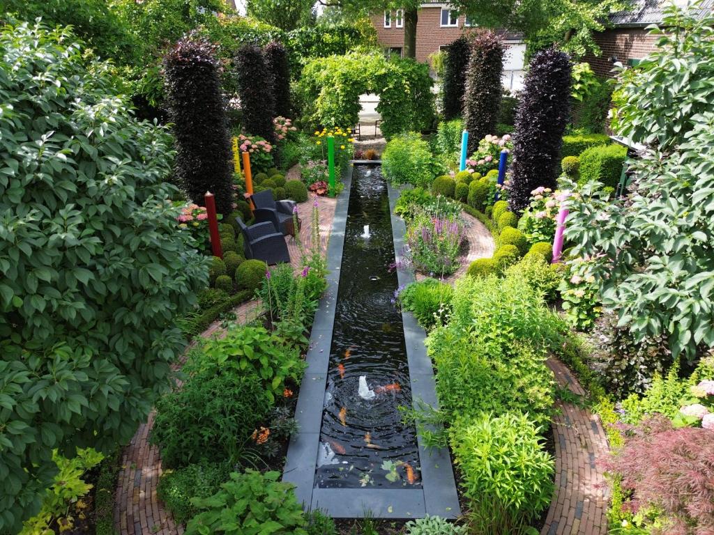 a garden with a model train in the middle at Appartement Siebengewald in Siebengewald