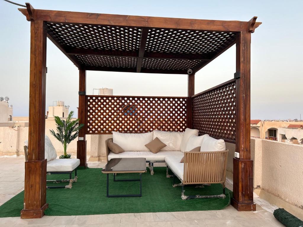 a gazebo with a couch and chairs on a patio at Blue Bay Village- Private Chalet in Marsa Matruh