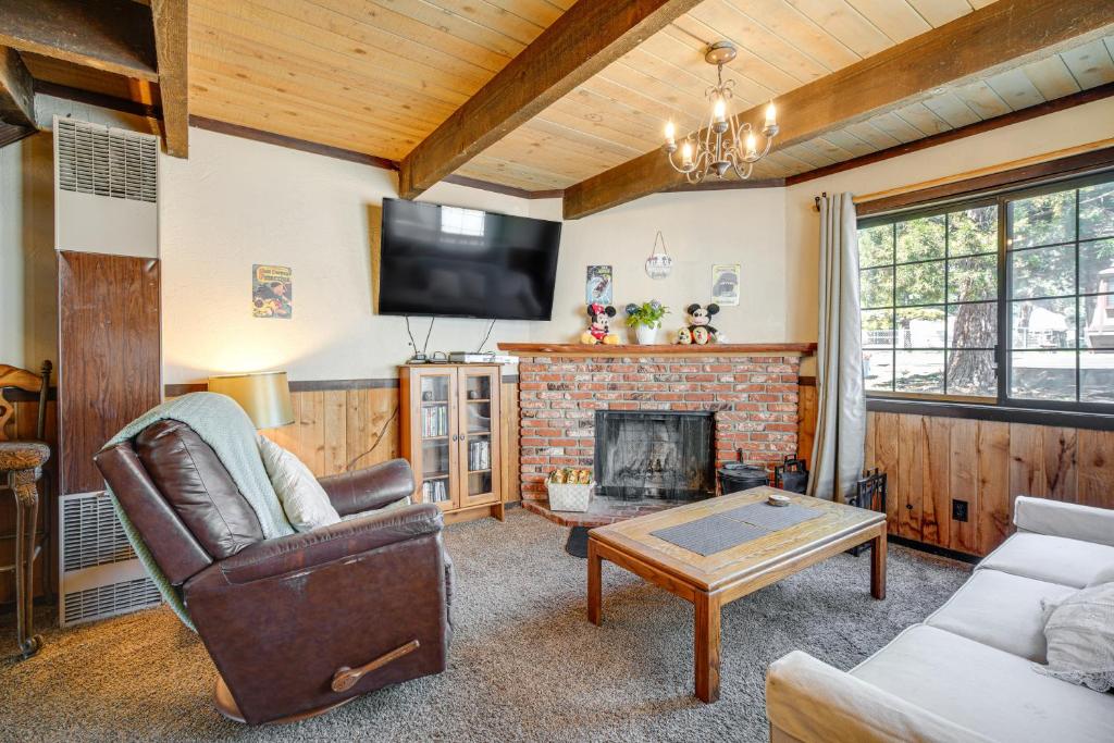 a living room with a fireplace and a tv at Near Lakes and Skiing Cozy Sugarloaf Cabin with Yard in Sugarloaf