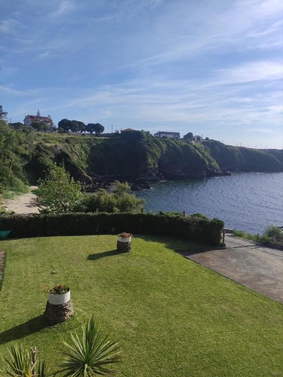 a park with a view of a body of water at Apartamentos Faxilda in Sanxenxo