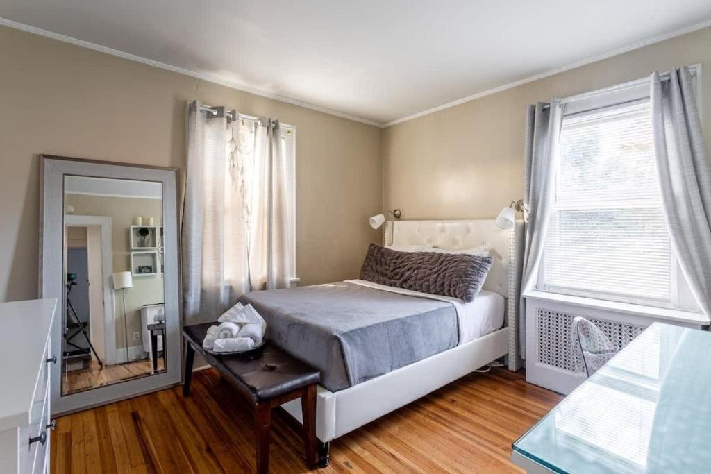a bedroom with a bed and a mirror at Bella room near downtown Train I-95 & beaches in Stamford