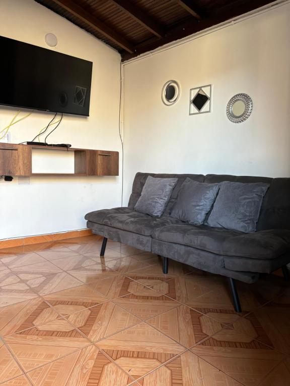 a living room with a couch and a flat screen tv at Apartamento en Bello (Medellín) in Bello