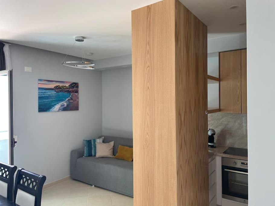 a living room with a couch and a kitchen at 2 Bedroom flat Shengjin in Margjonaj