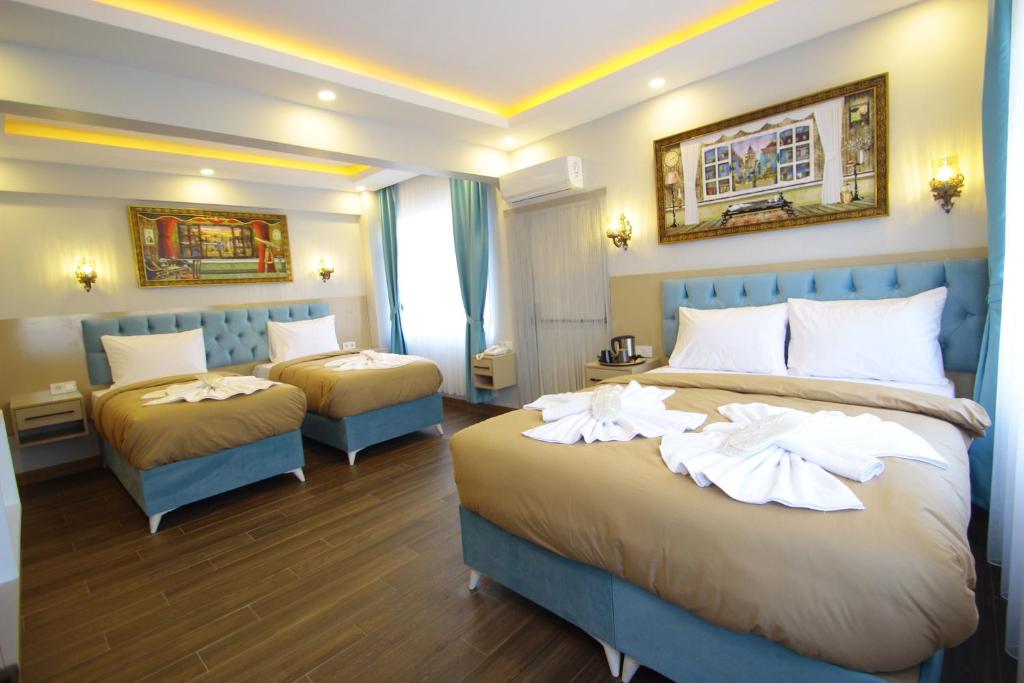 a hotel room with two beds with towels on them at Hira Hotel in Istanbul