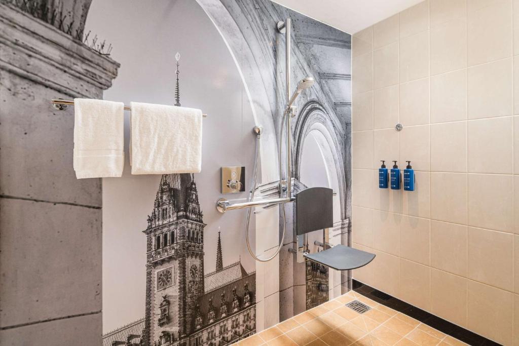 a bathroom with a shower with a drawing of a church at Radisson Blu Hotel, Hamburg Airport in Hamburg