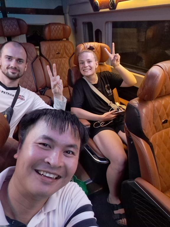 a group of people sitting in a train making the peace signs at Tam Coc Paradise Homestay in Ninh Binh