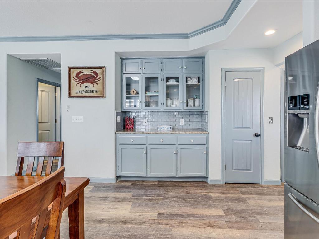 a kitchen with blue cabinets and a refrigerator at Shore Better Than Work in Rockport