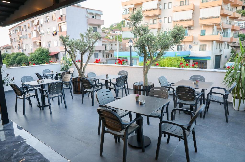 a row of tables and chairs on a patio at Vila Franko in Berat