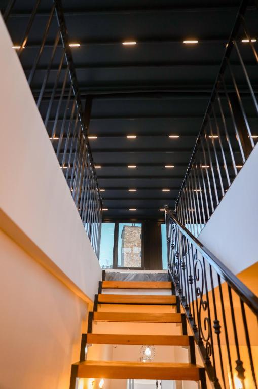 a staircase in a building with a black ceiling at Vila Franko in Berat