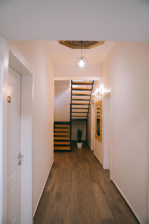 a hallway with white walls and a staircase in a house at Vila Franko in Berat