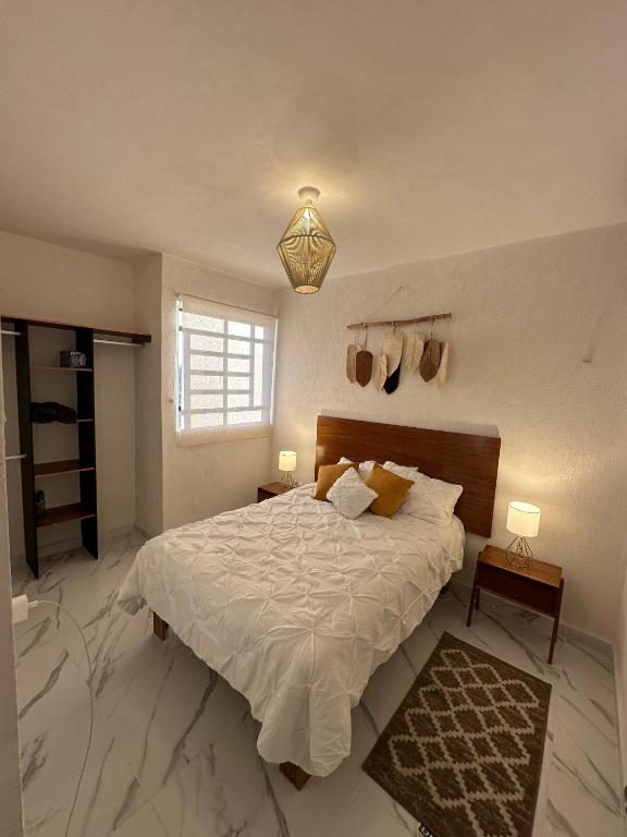 Ένα ή περισσότερα κρεβάτια σε δωμάτιο στο Departamento en aldea tulum 2BDR