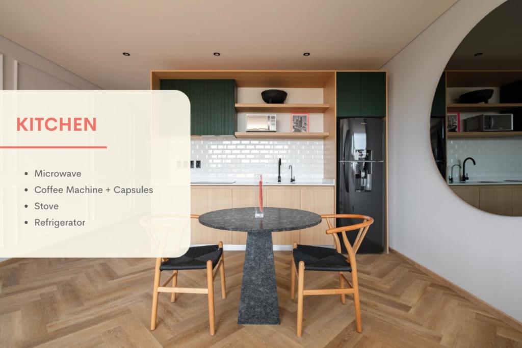 a kitchen with a table and two chairs at Casa Cibeles by Lumina in Mexico City