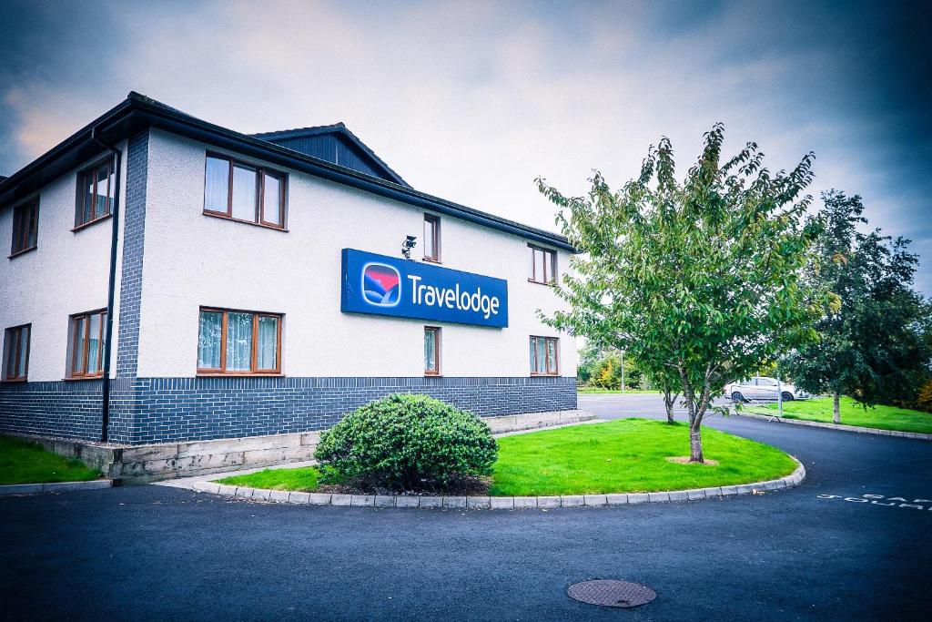 a building with a sign on the side of it at Travelodge Limerick in Limerick