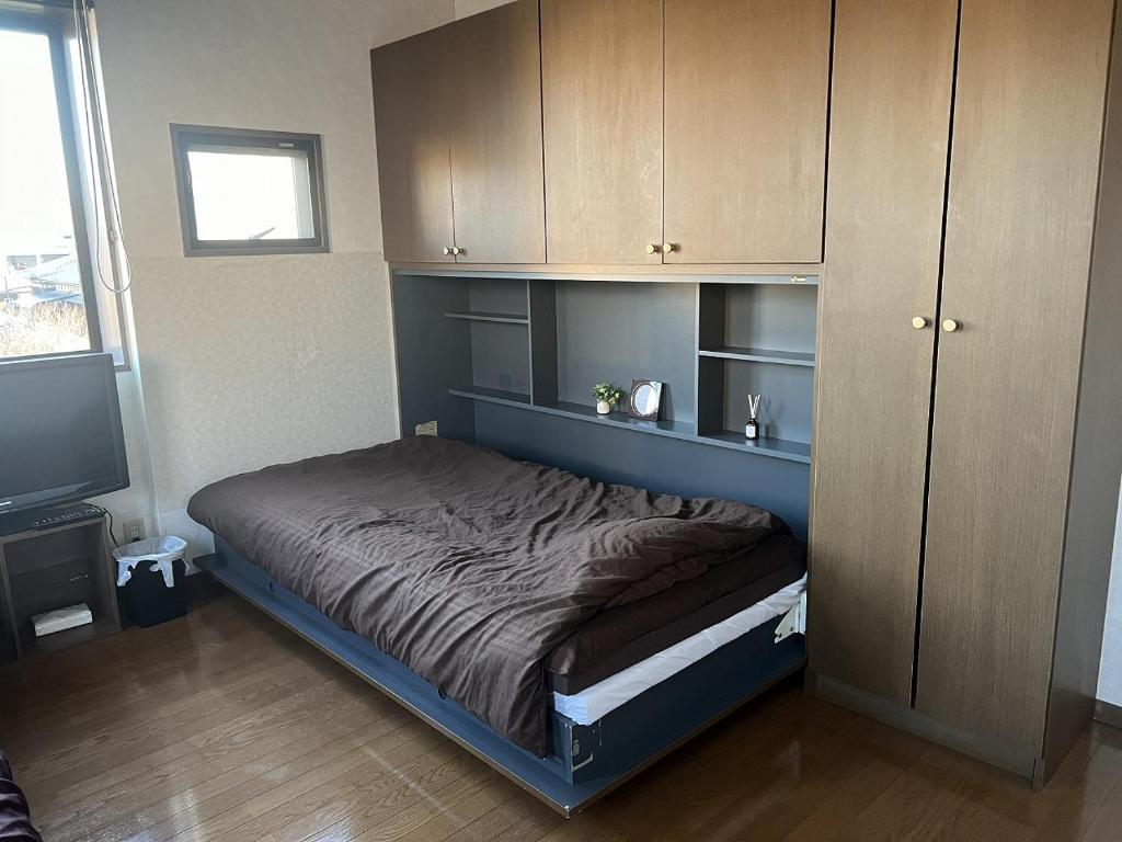 Postel nebo postele na pokoji v ubytování AppleRoom高瀬駅近202