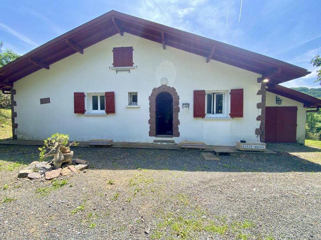 a white house with red windows and a driveway at Maison spacieuse à Macaye, au calme, 6-8 pers, proche Cambo, animaux admis, jardin, internet WiFi - FR-1-495-141 in Macaye