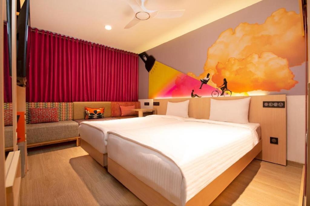 a bedroom with a bed and a couch at Ginger Pondicherry in Puducherry