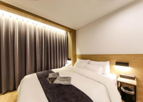 Postel nebo postele na pokoji v ubytování Divine Hotel