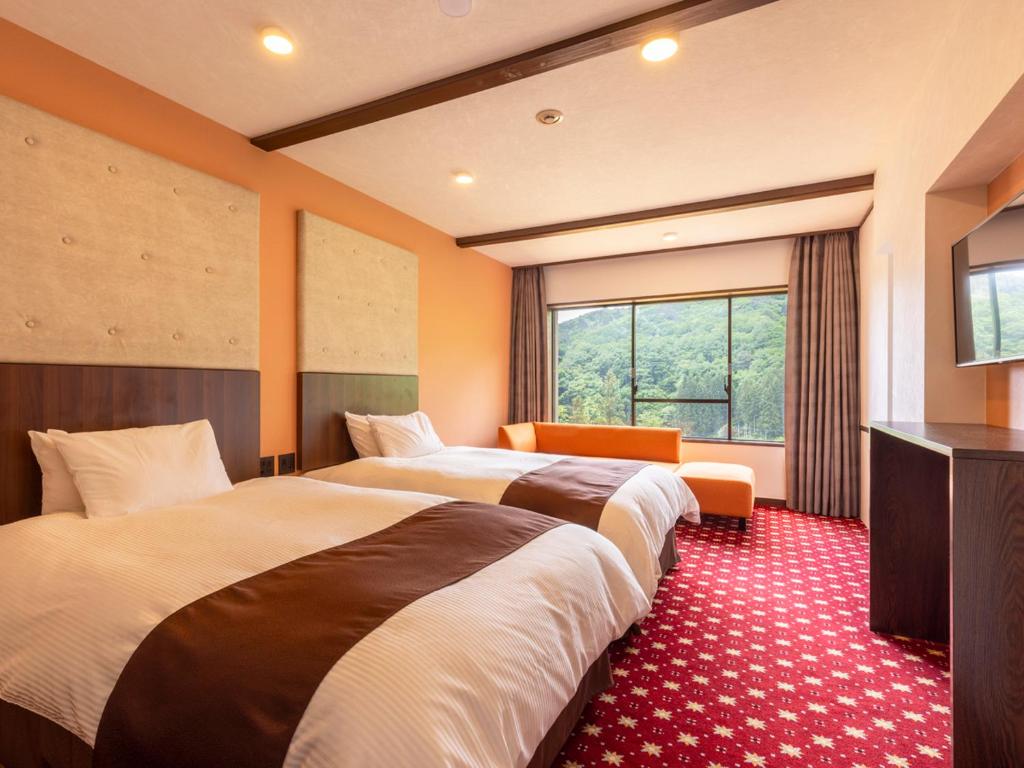 Postel nebo postele na pokoji v ubytování Hotel Koyokan