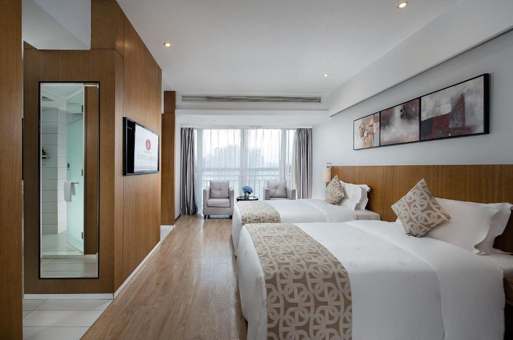 Postel nebo postele na pokoji v ubytování Hongdu Hotel