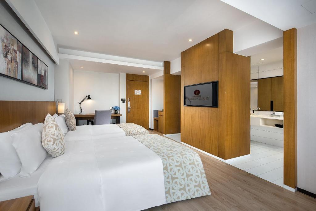Postel nebo postele na pokoji v ubytování Hongdu Hotel