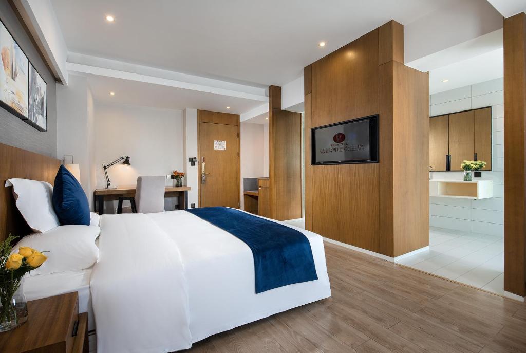 Postel nebo postele na pokoji v ubytování Hongdu Hotel