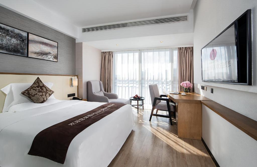 Postel nebo postele na pokoji v ubytování Hongdu Hotel