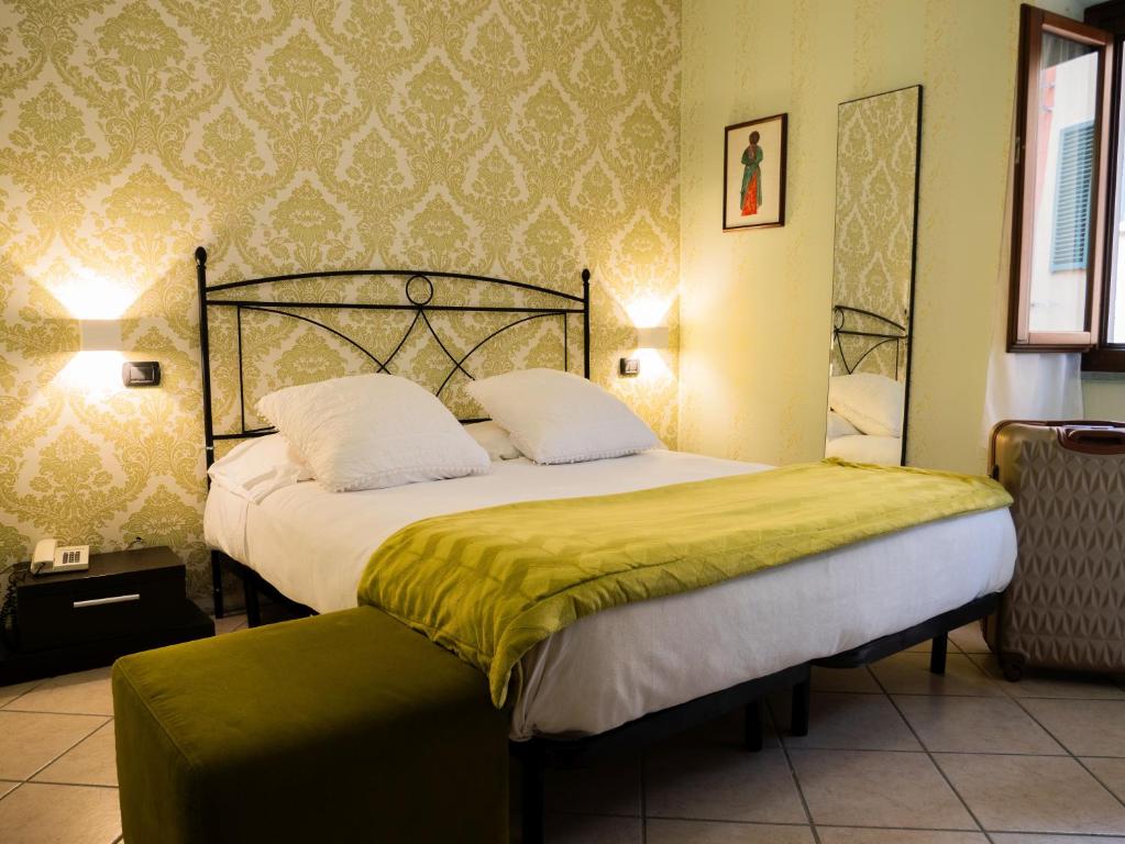 Łóżko lub łóżka w pokoju w obiekcie Hotel Ligure