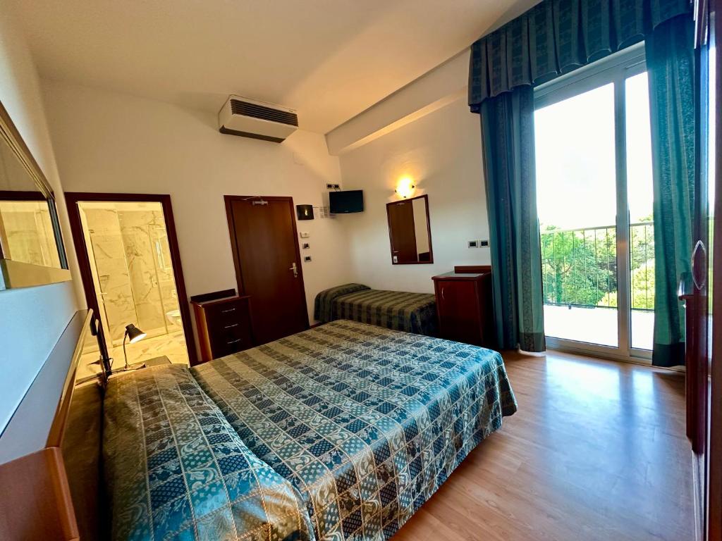 Postel nebo postele na pokoji v ubytování Hotel Beau Rivage Pineta
