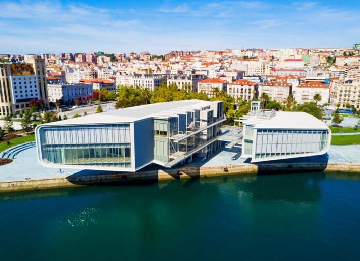 a large building next to a body of water at Hospedaje Botin in Santander