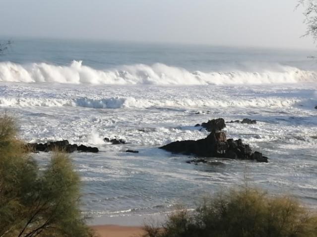 a body of water with some waves and rocks at Hospedaje Botin in Santander