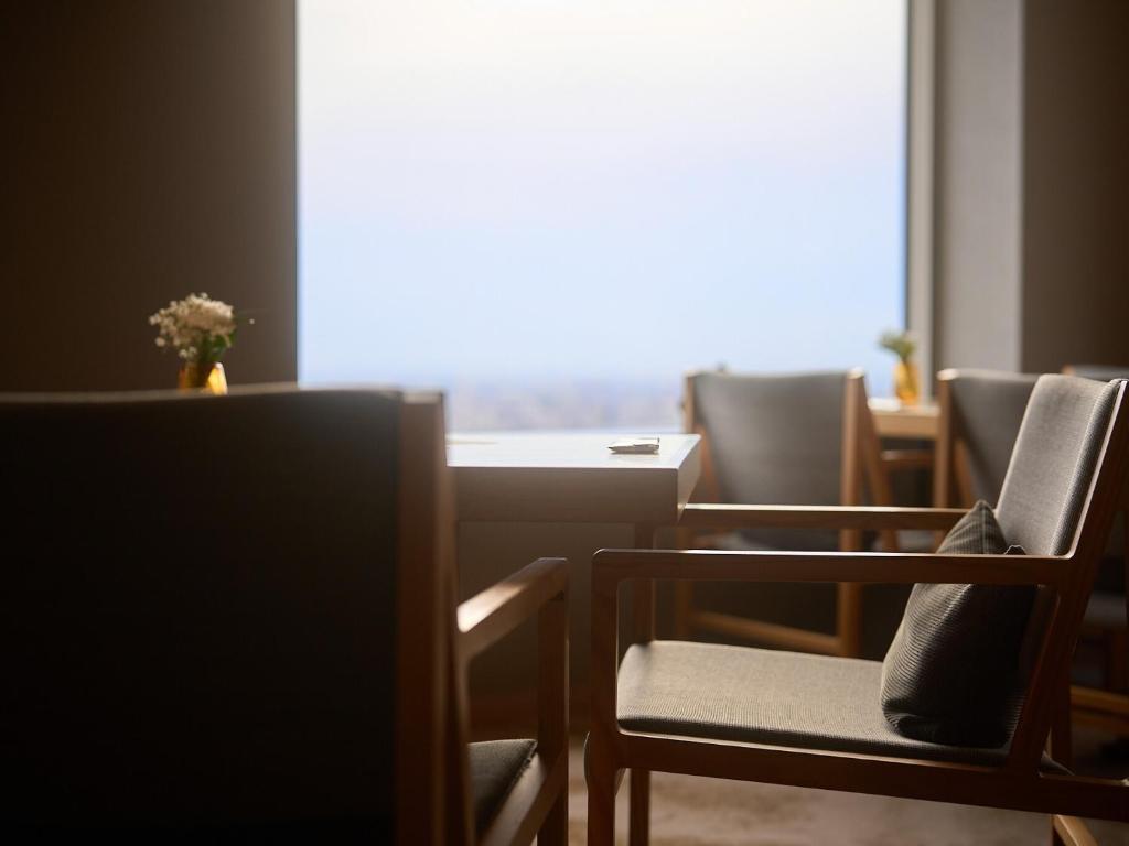 a room with chairs and a table and a window at Cerulean Tower Tokyu Hotel, A Pan Pacific Partner Hotel in Tokyo