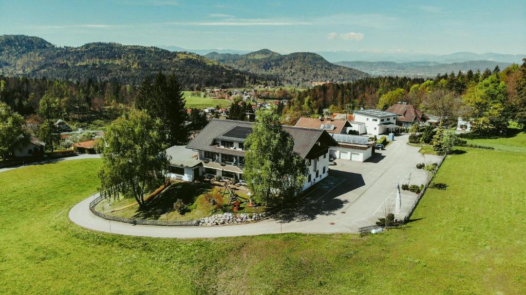 an aerial view of a large house in the mountains at Hotel Sonnenhof in Klagenfurt