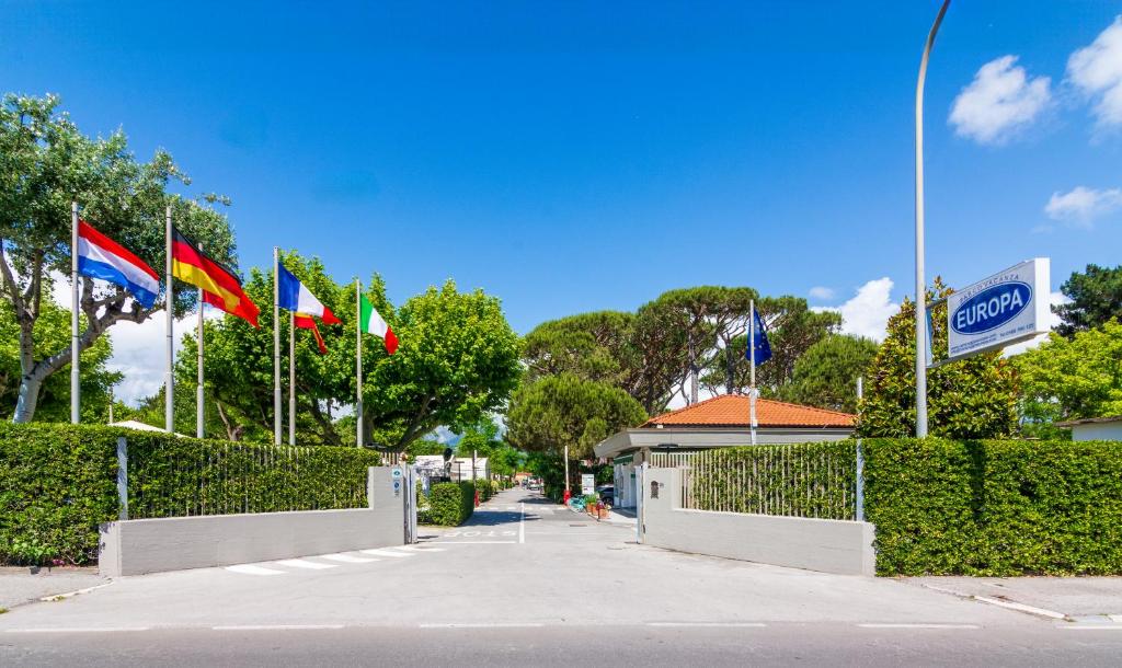 a row of flags in front of a building at Camping Europa in Marina di Massa