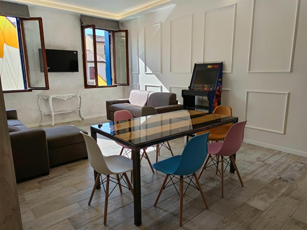 a living room with a table and chairs at Luxury Apartments Riva Vena in Chioggia