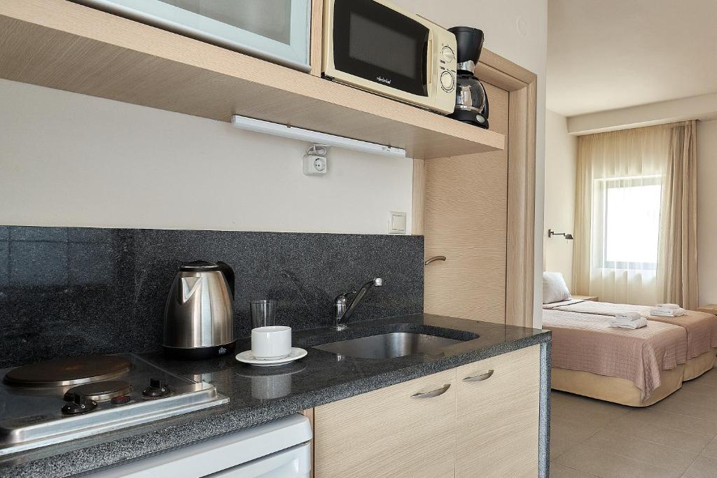 Postel nebo postele na pokoji v ubytování Creteco Hotel & Suites