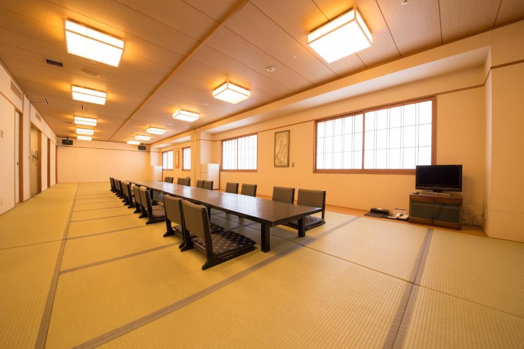 a conference room with a long table and chairs at Spa World HOTEL&RESORT in Osaka