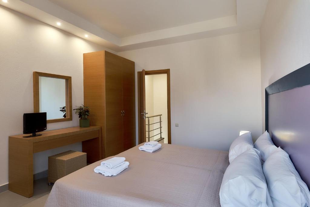 Postel nebo postele na pokoji v ubytování Creteco Hotel & Suites