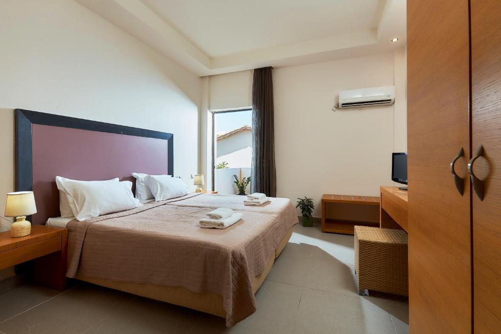 Postel nebo postele na pokoji v ubytování Creteco Hotel & Suites